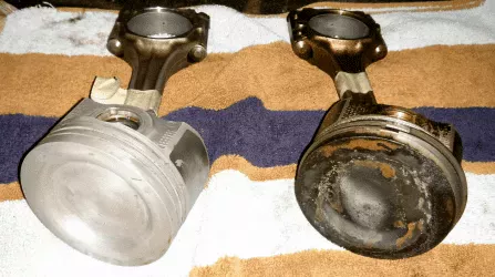 Side by side comparison of new vs old piston